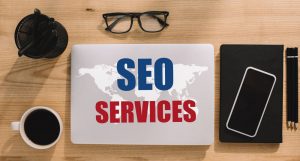 top view seo services with office gadgets - infintech designs