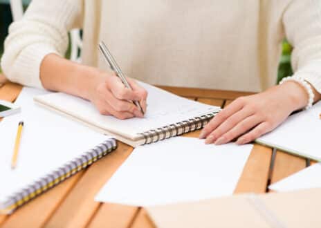 Woman making notes in her notepad - Infintech Designs